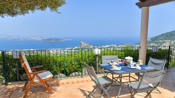 A terrace with a table set for tea, overlooking a coastal view. - Villa Bianca - A corner of paradise (Barano D'ischia)