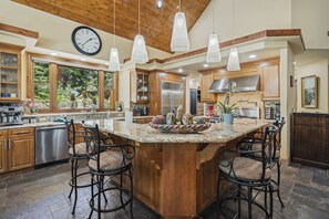 A spacious kitchen with a large island, wooden cabinets, and modern appliances. - 5BR Incline Village Retreat | Hot Tub & Mountain Views (Incline Village)