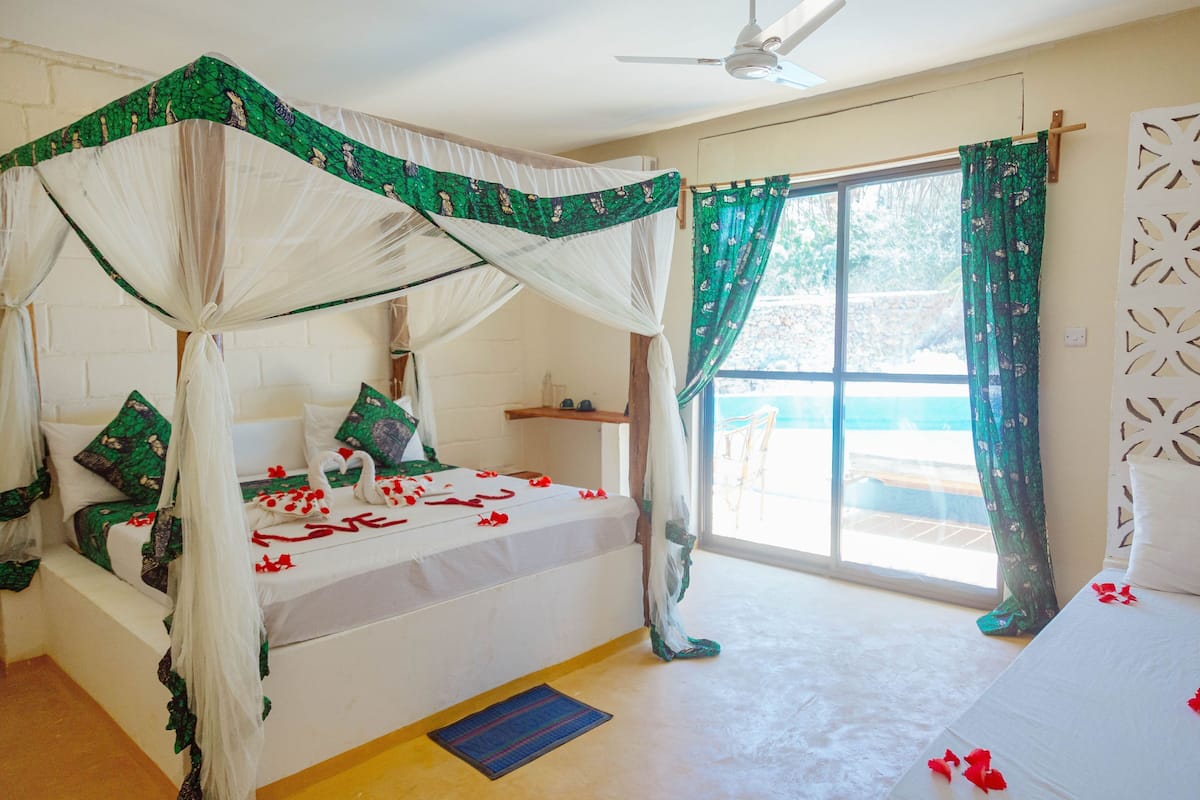 Desk, laptop workspace, iron/ironing board, bed sheets