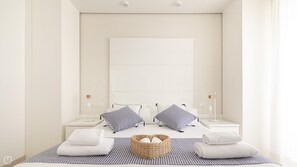A modern hotel room with a large bed, two bedside tables, a bedside lamp, a wall-mounted TV, and a wicker basket with towels. - Residenza Excelsior 607 (Vasto)