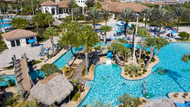 A resort with multiple swimming pools, palm trees, and lounge areas.