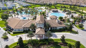 A residential area with multiple houses, a swimming pool, and well-maintained lawns.