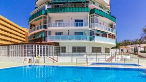 A multi-story hotel with balconies, a swimming pool, and a clear blue sky. - Rising Sun Apartment in complex Las Terrazas (Adeje)