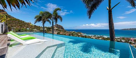 An infinity pool, a heated pool, pool loungers