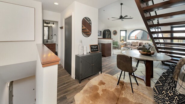 A modern kitchen with a wooden countertop, a dining area with a round table and chairs, and a staircase with a wooden railing. - Lulu 6J Walk to Lift 7 + Pool & HotTub - 2 Bedroom+Loft, 3 Bathroom, Sleeps 6 (Telluride)