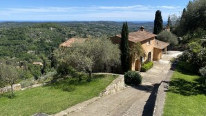 A hillside villa with a stone pathway leading to a building with a tiled roof. - Splendid 6-bedroom villa with sea view in Grasse (Grasse)