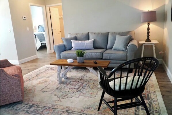 Relax in this inviting living space with a sofa, coffee table, and comfortable chair.