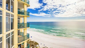 A multi-story hotel with balconies overlooking a beach. - Jade East Towers~Beach Front w/Amazing Unparalleled  Sunrise and Sunset Views (Jade East Towers , Destin)