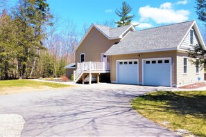 A two-story house with a covered porch, a garage, and a driveway. - Gorgeous Conway Home A/C, Hot Tub & Full Game Room (Conway)