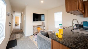 A modern kitchen with a granite countertop, wooden cabinets, and a built-in oven.