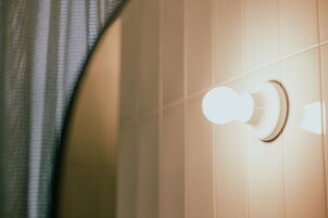 Een badkamer met een handdoekhouder en een lamp.