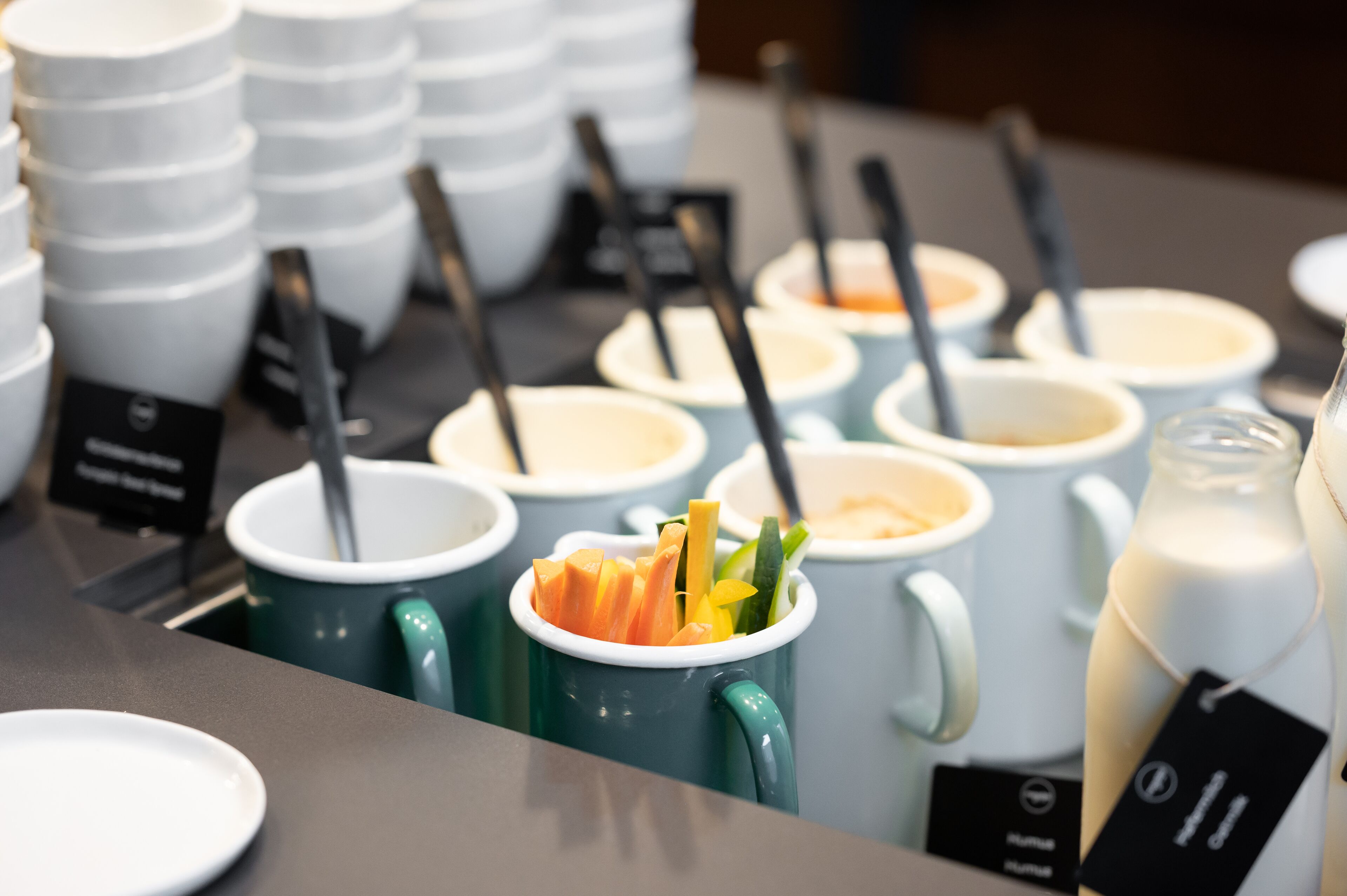 Una mesa de buffet con diversos alimentos y utensilios.