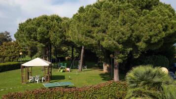 A park with a gazebo, picnic tables, and playground equipment.