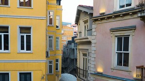 A narrow alleyway between buildings with balconies and a fire escape. - The Havana Residence (Istanbul)