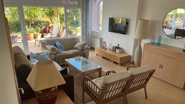 A living room with a sofa, armchairs, a coffee table, and a TV. There is a window with a view of the outdoors. - Stunning Villa with Private Heated Pool & Terrace JAC3 (Torre-Pacheco)