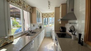 A kitchen with a window, a stove, and a sink. - Stunning Villa with Private Heated Pool & Terrace JAC3 (Torre-Pacheco)