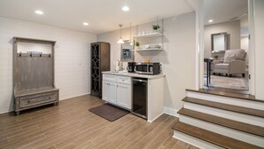 A modern kitchen with white cabinetry, a built-in microwave, and a coffee maker. - Minutes to Downtown Charleston, Shem Creek & Beach (Mount Pleasant)