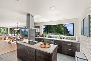 Enjoy meals in the kitchen with a stove, ample counter space, and a scenic view.