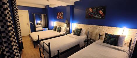 Standard Quadruple Room | Free minibar, individually decorated, desk, laptop workspace