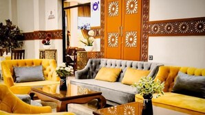 A hotel lobby with a sofa set, a coffee table, and decorative elements. - EL MOUSSAFIR HOTEL (Marrakech)