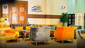 A lobby with a sofa set, a fountain, and a sign for 'El Moussafir' hotel. - EL MOUSSAFIR HOTEL (Marrakech)