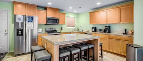 Enjoy cooking in this well-lit kitchen with a central island and stainless steel appliances.