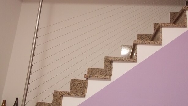 A staircase with a metal handrail and granite steps, leading up to a landing. - Malu's House (Castelluccio Superiore)