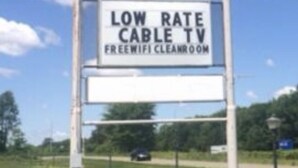 A sign for a Super 9 store advertising low rate cable TV and free wifi in the restroom. - Super9 inn (Albion)