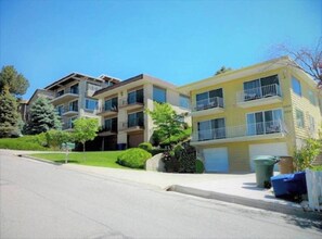 A row of modern multi-story apartment buildings with balconies, a well-maintained lawn, and a clear sky. - “Stunning Views!” Luxury 4 Bedroom, 2 Bathroom Vacation Duplex in Downtown Salt Lake Capitol Hill (Salt Lake City)