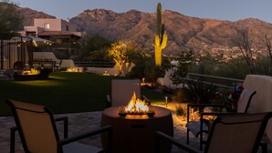 A patio with a fire pit, outdoor seating, and a view of mountains. - Upscale Home: Amazing Views! Pool & Hot Tub (Tucson)
