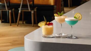 A bar area with stools and a bar counter.