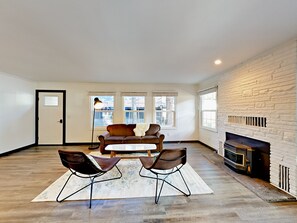 Relax in this open-plan living space with a fireplace and comfortable seating area.