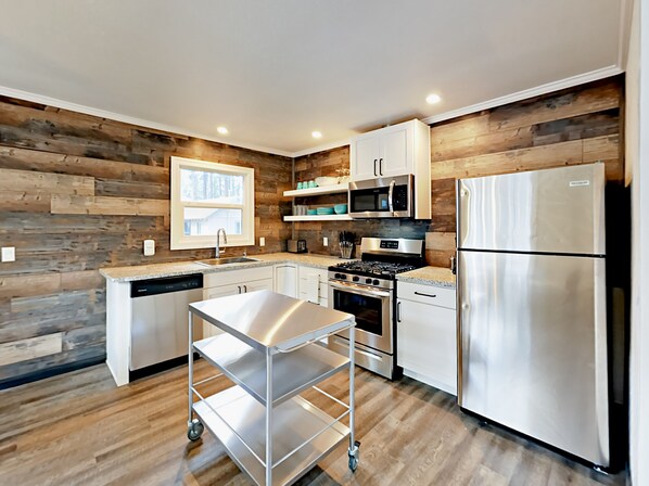 Enjoy cooking in this kitchen with a central island, sink, and ample counter space.