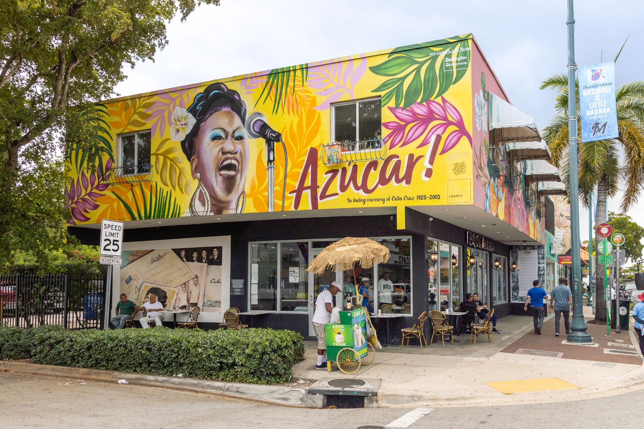 A colorful building with a mural and a sign that reads "Azucar!"