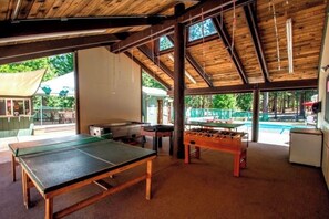 Enjoy games and leisure time in this spacious room with a ping pong table, foosball table, and pool table.