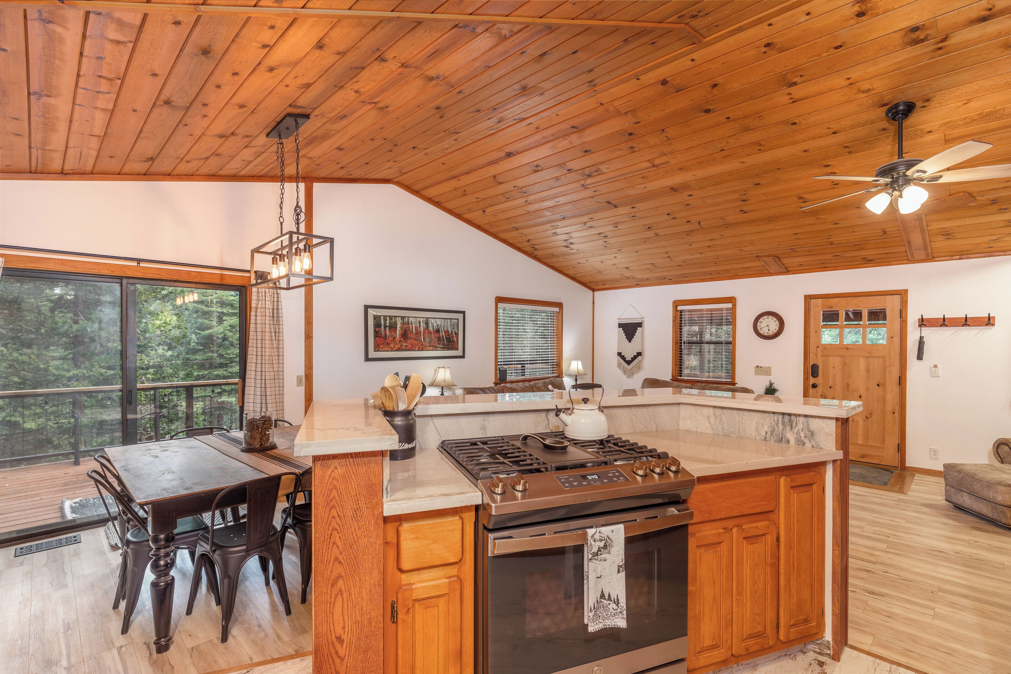 A spacious kitchen with wooden cabinets, a large island, and a built-in oven.