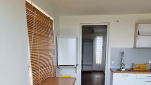 A compact kitchen with a white refrigerator, a sink, and a wooden countertop. - Building (Les Anses-d'Arlet)