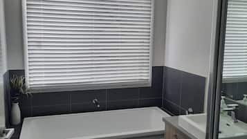 Combined shower/bathtub, towels, toilet paper