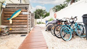 A gated property with a wooden fence, a smoke-free sign, and bicycles parked outside. - 4 Nights Left -Perfect Family-Friendly Condo 5 Houses from the Ocean-Beach Block (Dewey Beach)