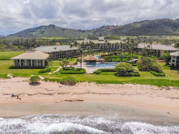A resort with multiple buildings, a central pool, and a beach area. - Kauai Beach Villa Walk to Beach, full kitchen, separate living room FREE PARKING (Lihue)