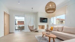 A modern living room with a sofa, a hanging chair, and a coffee table. - COSTAVASIA Apartments (Velo-Vocha)
