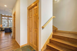 Stairs lead to an upper floor, flanked by a door and a window.