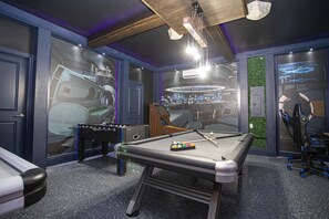 Enjoy games and drinks in this stylish room with a pool table, foosball table, and bar area.