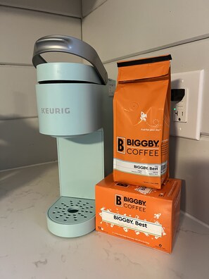 A Keurig coffee maker and two Biggby Coffee bags on a kitchen counter. - Modern Farmhouse, Sleeps 8, North of St. Joseph (Benton Harbor)