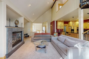 Cozy living area with a fireplace, sofa, and dining space.