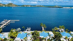 A coastal resort with a marina, palm trees, and a clear view of the ocean. - Serenity Penthouse - The Pinnacle of Luxury (Maho)