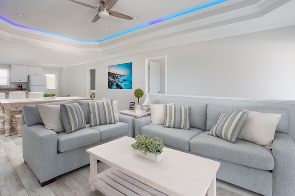 Upstairs living room with guest controlled LED tray lighting on the ceiling.