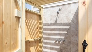 A wooden outdoor shower with a tiled wall and a metal faucet. - Pool Paradise: 8 bedroom 6 bath private pool sleeps 20 across from the beach! (Murrells Inlet)