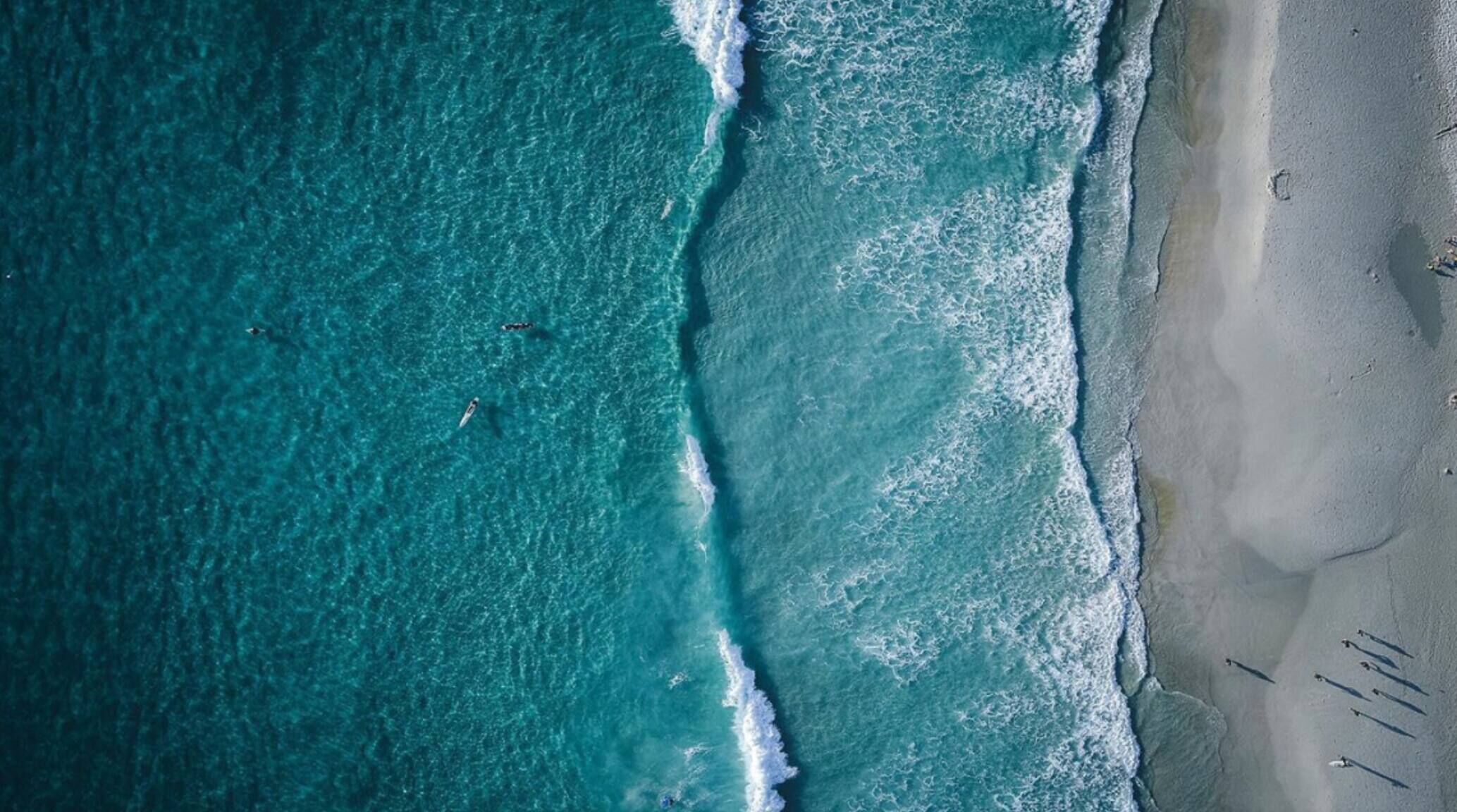 A beach with waves crashing onto the shore.