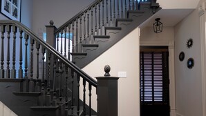 A staircase with black balusters and a black handrail leading to a landing.